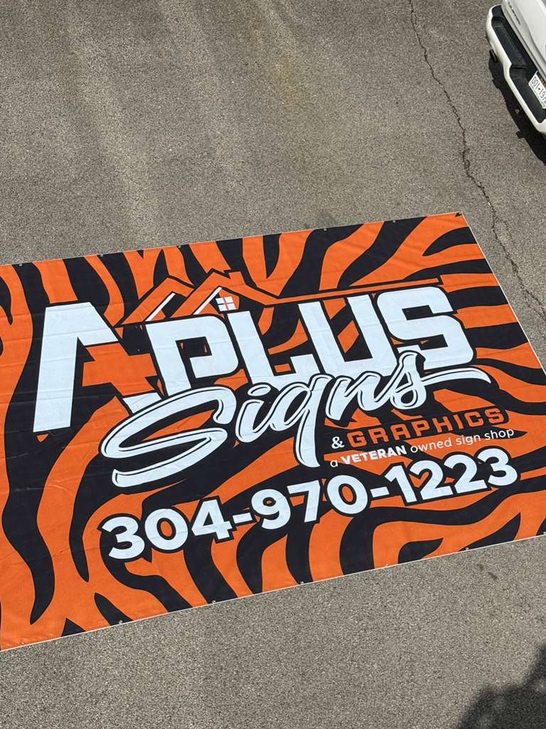 A Plus Signs & Graphics circular logo sign